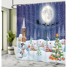 a shower curtain with a snowman and santa clause flying over the town at night