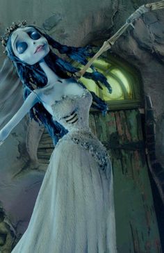 an animated image of a woman in a white dress with blue hair and makeup on her face