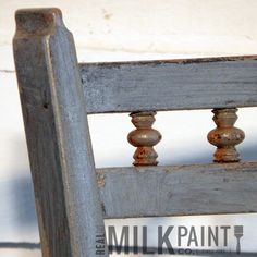 an old wooden chair with three knobs on it