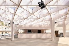 an empty parking garage with white walls and ceiling