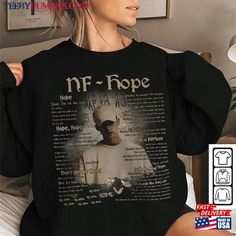 a woman wearing a black shirt with the words nf hope on it and an image of