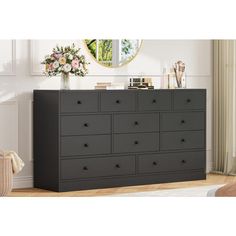 a black dresser with drawers in a room