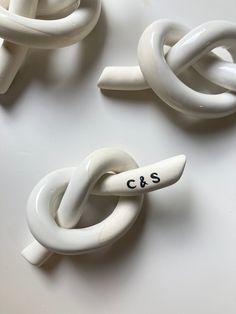 three pieces of art made to look like links and chains with the word c & s written on them