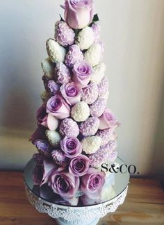 a cake made out of flowers on top of a glass plate with the words tried this pin? be the first to share how it went