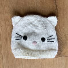 a knitted hat with a cat's face on it