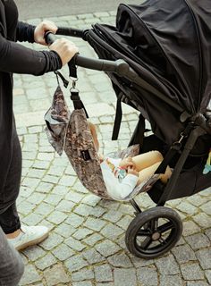 a woman pushing a baby in a stroller