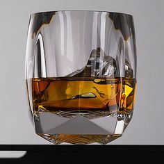 a glass with some liquid in it sitting on a table