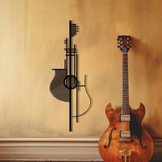 a wooden guitar sitting on top of a hard wood floor next to a wall clock