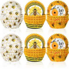 four honey cupcakes with bees on them, each decorated in different patterns and designs