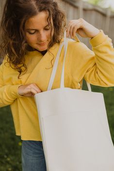 A classic leather tote is a wardrobe staple every girl needs in their life. And these beauties are here in our fun new colours to add a pop of color to your wardrobe! Its buttery soft leather and minimalistic yet functional design makes this a bag that will fit seamlessly into your life. Whether it’s tagging along for a weekend trip to the farmer’s market, holding all your work or school necessities, or traveling with you around the world, you’ll find this beautiful genuine leather tote the bag Minimalist Cream Tote Shoulder Bag, Minimalist Cream Bag For Everyday Use, Cream Minimalist Bag For Everyday, Cream Minimalist Tote Bag, Minimalist Cream Tote Bag, Simple Cream Bag For Everyday Use, Minimalist Everyday Cream Bag, Simple Everyday Bag, Everyday Tote Shoulder Bag For Spring