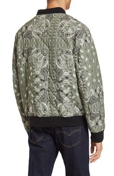 Update your signature style with this cool quilted bomber jacket that features an all-over bandana print. 27'' length (size XL) Stand collar Long sleeves Zipper front Ribbed cuffs and hem Zipper flap pockets Bandana print Woven Shell: 100% polyester; Body lining: 100% nylon; Sleeve lining: 100% polyester; Filler: 100% polyester; Knit: 99% polyester, 1% spandex Machine wash cold, tumble dry low Imported Model stats: 6'1" height, 32" waist. Model is wearing size XL. Bandana Print, Signature Style, Stand Collar, Nordstrom Rack, Levi's, Zip Ups, Bomber Jacket, Long Sleeve Blouse, Nordstrom