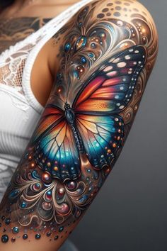 a woman's arm with a colorful butterfly tattoo on the left side of her arm