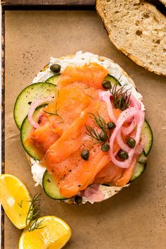 an open face sandwich with smoked salmon and cucumbers