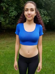 "This short sleeve form-fitting blue crop top is made from a stretchy cotton spandex fabric.   Worn With: Our Black Ultra Low Rise Capri Leggings. The model is 5'5\" and wearing a size small.  Size Chart (inches):                              S            M           L Bust                  26-30   30-34     34-36 Natural Waist  23           24            26 Length                12             13     14  Materials:  95% cotton, 5% spandex. Custom print on this crop top: Yes. You can request your own design on this crop top. There is a $16 custom design fee added to the price of the top. Local Pickup Available: Yes.  If you live in the south bay area in San Diego, you can pick up your crop top and receive up to 20%off.  Payment will be due on pickup. Country of Manufacture: Made in Califor Stretch Cotton Sports Crop Top, Stretch Cotton Crop Top For Sports, Seamless Stretch Cropped T-shirt, Sporty Stretch Cropped Shirt With Short Sleeves, Solid Stretch Short Sleeve Crop Top, Basic Short Sleeve Crop Top For Workout, Stretch Seamless Short Sleeve Top, Casual High Stretch Blue Crop Top, Basic Stretch Crop Top Activewear