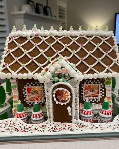 an elaborate gingerbread house is displayed on a table