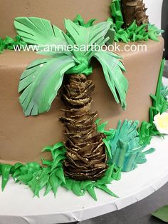 a cake decorated with palm trees and leaves