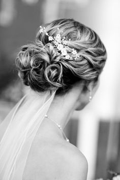 a woman in a wedding dress with a veil on her head