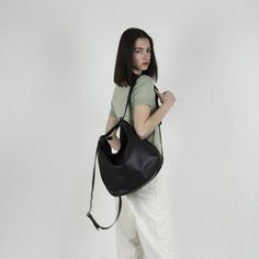 "Black convertible leather bag from soft Italian leather : Converts from backpack to shoulder bag and crossbody bag with the single use of one strap. The main style of the bag is a soft and slouchy hobo bag. The permanent long strap on the bag can be easily adjusted to your desired length in order to wear the bag on your shoulder, as a crossbody bag or as a backpack. **Important point is that when you adjust the strap to a backpack the strap is stable and does not slide from one side to the othe Versatile Hobo Bucket Bag For On-the-go, Soft Leather Hobo Bag For On-the-go, Adjustable Strap Hobo Shoulder Bag For On-the-go, On-the-go Hobo Shoulder Bag With Adjustable Strap, Modern Hobo Shoulder Bag For On-the-go, Black Hobo Bag With Adjustable Strap For On-the-go, Black Bucket Bag Backpack For Shopping, Versatile Hobo Bag With Adjustable Strap For Daily Use, Black Shopping Bucket Backpack Bag