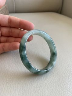 "🌈 Jade Bangle 53.0mm (2.09\"), Oval Shape, Green and Oil Green 🌷 Untreated Natural Jadeite/ Grade A Jade, Certified 🌷 Jade from Myanmar/ Burma 🌷 100% handmade carving 🌷 Shape : Oval 🌷 Inner diameter : 55.2 x 49.7 mm ----> fit for round shape 53.0mm / 2.09\" 🌷 Color : Green and Light Green 🌷 Free standard shipping from Hong Kong with tracking included 🌷 Take approximately 7-21 days to arrive worldwide ❤️ In Chinese Culture: Young people wear jade pendant will have a prosperous life, Luxury Green Oval Bracelet, Green Gemstone Bracelets, Oval Jade Bangle As Gift, Classic Green Bangle Bracelet, Luxury Green Bracelets, Elegant Oval Green Bangle, Elegant Green Oval Bangle, Classic Green Round Bangle, Lavender Green