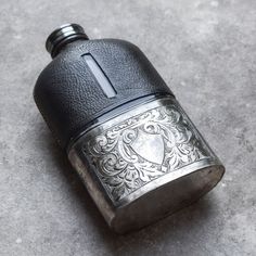 an old fashioned flask shaped like a lighter