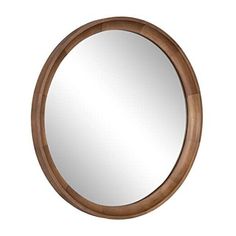 a round wooden mirror hanging on the wall