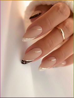 a woman's hand with long, shiny nails and gold rings on her fingers