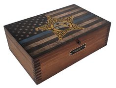 a wooden box with an american flag and a police badge on the lid is shown