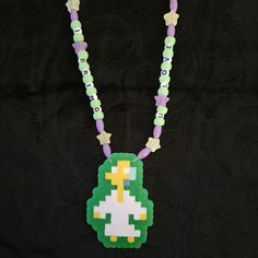 a necklace made out of plastic beads with an image of a pacman on it