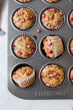 freshly baked muffins in a baking pan ready to be eaten with pink toppings