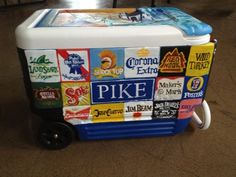 the cooler is covered with many different types of stickers on it's sides