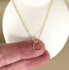 This tiny floating 14k gold filled open heart charm necklace is finished with a delicate chain and lobster claw clasp.  The necklace is available in customizable lengths from the drop down menu at check out. The heart charm is approximately 10mm.  It's wonderful on its own or layered with other necklaces.  A sweet gift for bridesmaids, mom on mother's day or a special woman on any occasion!  You may also like to  check out more of my necklaces here: http://etsy.me/2kMdyB0 Free first class USPS shipping within the USA. Simple Gold Necklaces For Valentine's Day, Delicate 14k Gold Open Heart Charm Necklace, Gold Minimalist Heart Necklace For Mom, Dainty 14k Gold Filled Necklace For Valentine's Day, Minimalist Gold Heart Necklace As Gift For Mom, Minimalist Gold Heart Necklace For Mom, Dainty Open Heart Yellow Gold Charm Necklace, Minimalist 14k Gold Filled Open Heart Jewelry, Dainty Handmade Gold Heart Necklace