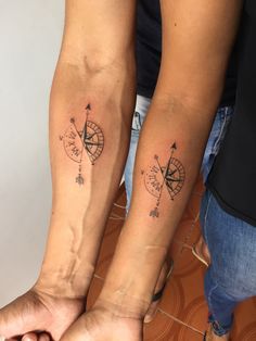 two people with matching tattoos on their arms