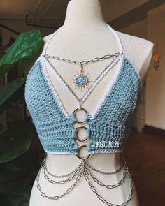 a crocheted top with chains attached to it