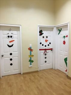 three white doors decorated with snowmen and christmas decorations in an empty room on the floor