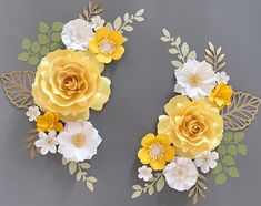 two yellow and white paper flowers on a gray background