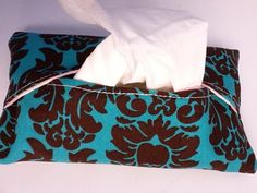 a blue and brown pillow with a tissue in it