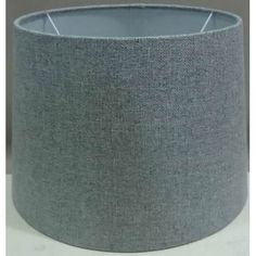 a grey lamp shade on a white table