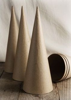 three cement cones sitting on top of a wooden table