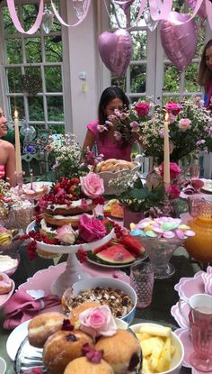 a table filled with lots of food and flowers