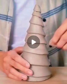 someone is making a paper christmas tree out of clay