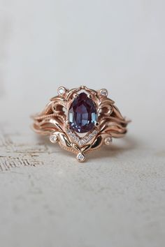 a close up of a ring with a stone in the middle and diamonds around it