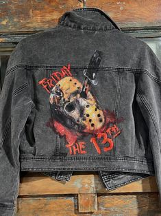 Hand painted Friday the 13th jean jacket! 🖤🔪 Painted on a Women's small cropped black jean jacket and inspired by the movie Friday the 13th! I used fabric and acrylic paint to create this piece of artwork.  To Clean: Do not put in the washing machine or scrub clean, instead: spot clean using a rag and soap, using circular motions to get stains/messes clean. Feel free to contact me with more questions!  I create custom painted jackets made to order. See my Etsy account for more details! Paint On Jacket, Jean Jacket Painted, Hand Painted Jean Jacket, Movie Friday, Custom Jean Jacket, Friday 13th, Black Jean Jacket, Team Jackets