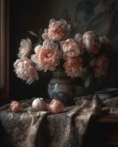 a vase filled with pink flowers on top of a table next to a window sill