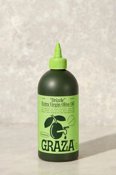 a bottle of grizzly extra virgin olive oil sitting on a countertop next to a wall