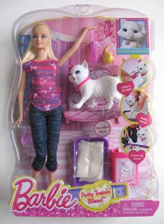 the barbie doll is in her pink and blue outfit with white cat on it's back