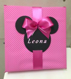 a pink minnie mouse gift bag with a name on it