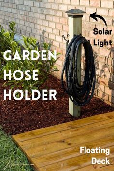 the garden hose holder is attached to a wooden deck