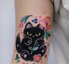 a black cat with flowers on it's arm is shown in this tattoo design