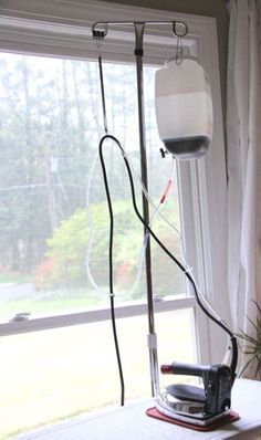 an ironing board sitting on top of a table next to a window