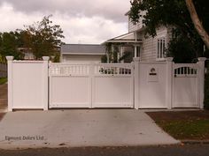 a white picket fence in front of a house